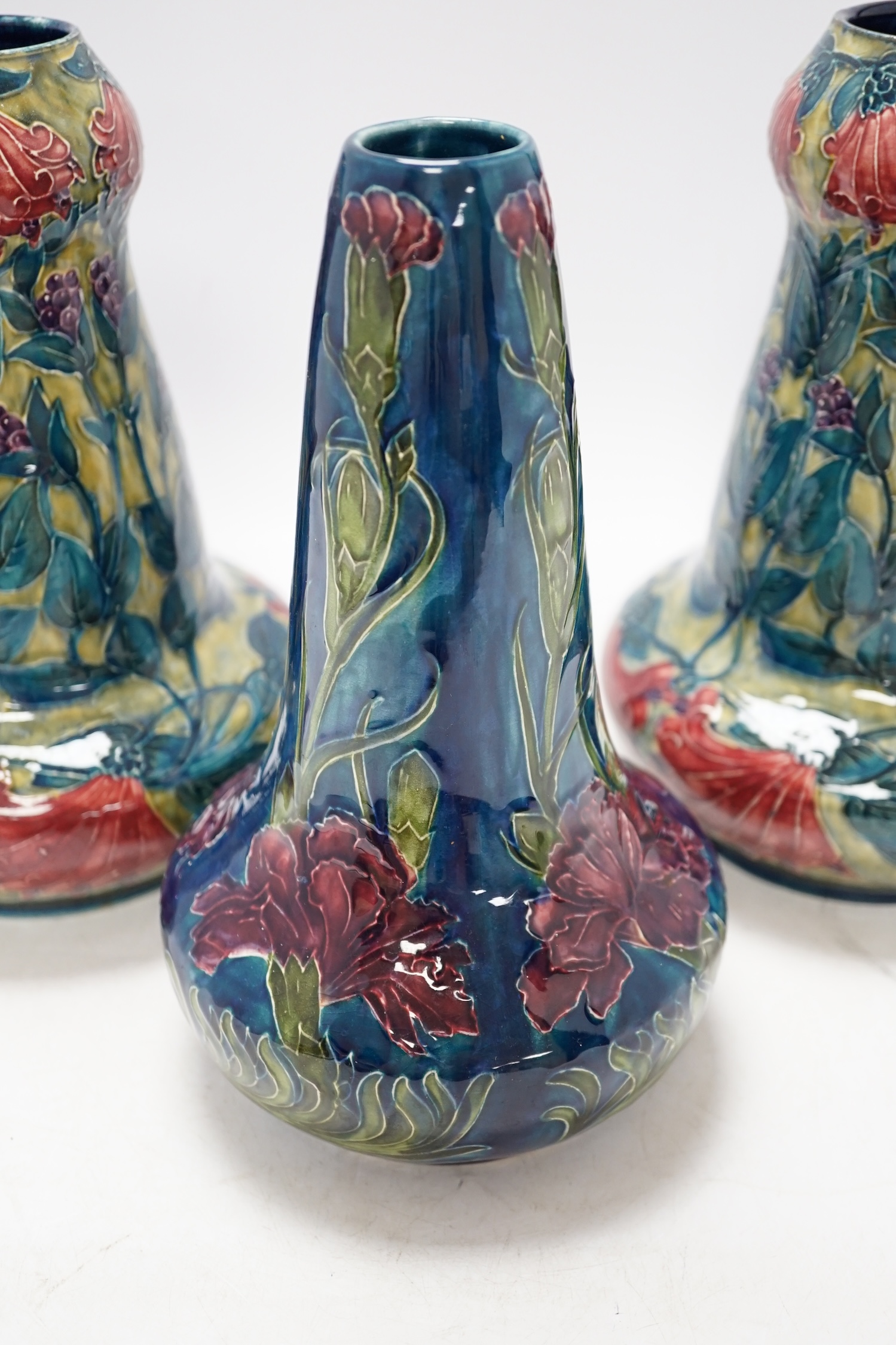 A pair of Hancock & Sons Morrisware vases, and another, designed by George Cartlidge, decorated with stylised flowers, 24cm high. Condition - fair to good, crazing throughout
